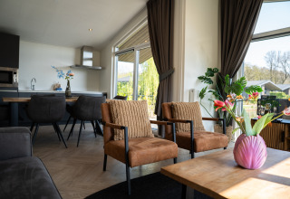 Sala luminosa en Villa Waterzicht Luxe con bañera de hidromasaje 6, Holiday park Molenvelden, ventanales grandes.