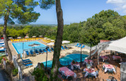 Zicht op zwembad en buitenterras van Sandaya Le Pianacce vakantiepark in het zonnige Toscane, Italië.