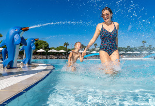 Mutter und Kind spielen im Pool im Sandaya Europa Village, Venetien, Italien, bei strahlendem Sonnenschein.