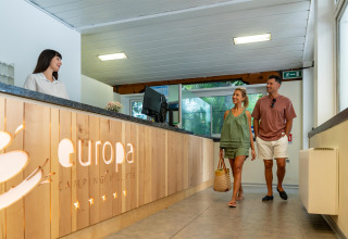 Par ankommer til receptionen på Sandaya Europa Village feriepark i Veneto, Italien og bliver budt velkommen.