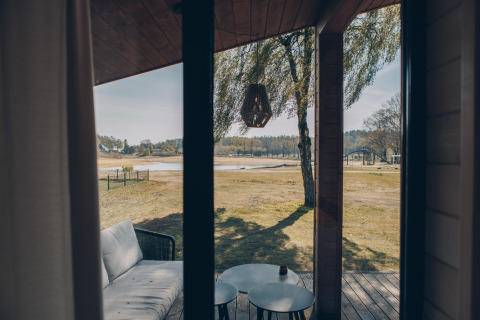 Vue depuis The Beach House à Wilsumer Berge en Allemagne, avec terrasse, canapé et paysage naturel à l’arrière.