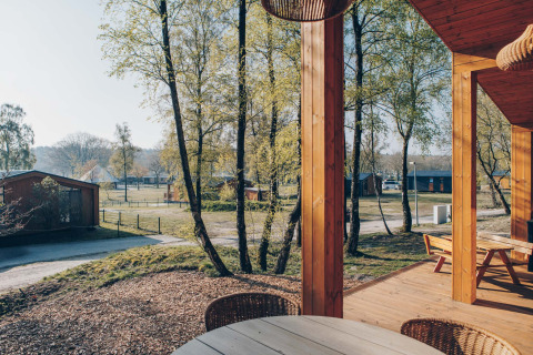 View from the wooden terrace at Beach Side Scandi lodge in Wilsumer Berge, Germany, surrounded by nature.
