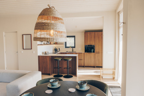 Bright, modern kitchen and dining area in the Beach Side Scandi lodge at Wilsumer Berge, Germany.