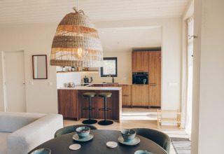 Bright, modern kitchen and dining area in the Beach Side Scandi lodge at Wilsumer Berge, Germany.