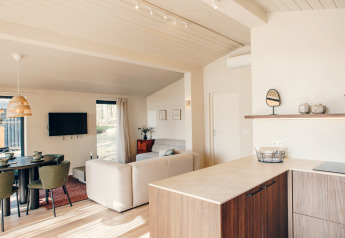 Helles, skandinavisches Beach Side Scandi Lodge-Interieur mit Küche, Sofa und Essbereich in Wilsumer Berge.