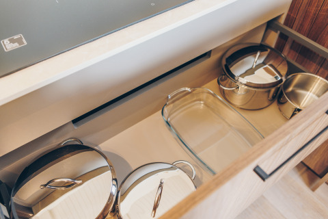 Drawer with pots and glass baking dish in the kitchen at Beach Side Scandi lodge, Wilsumer Berge, Germany.
