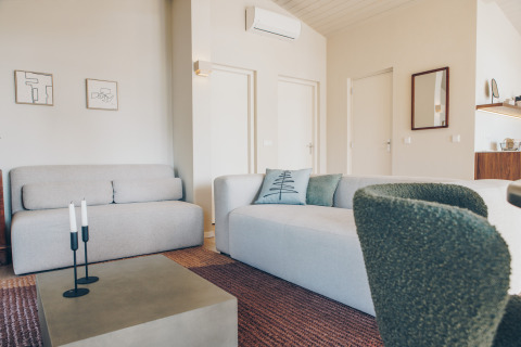 Modern living room in Beach Side Scandi lodge at Wilsumer Berge, Germany, with bright, minimalist decor and furniture.