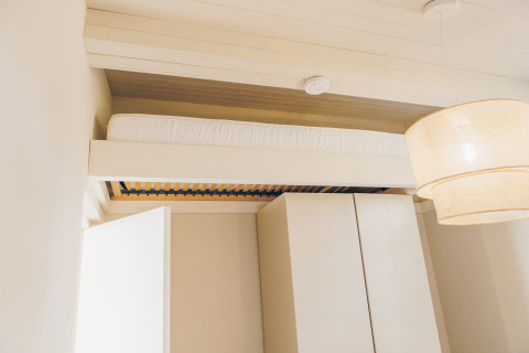 Modern loft bed at Beach Side Scandi lodge, Wilsumer Berge, Germany, featuring minimalist decor.