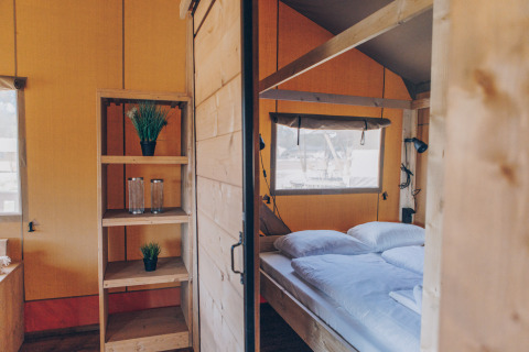 Interieur van een comfortabele slaapkamer in de 'Glamfield Lodge' Premium safaritent bij Wilsumer Berge, Duitsland.