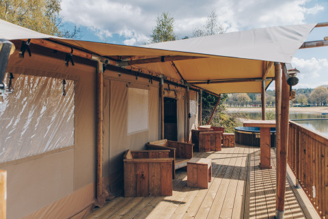 Terras bij safaritent Glamfield Lodge Premium op Wilsumer Berge in Duitsland met uitzicht op het meer.