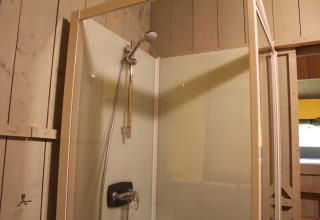 Shower cabin with glass panels in a safari tent with private sanitary at Family park Goolderheide, Belgium.
