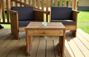 Outdoor wooden patio furniture with black cushions at a safari tent in Mini campsite Marina Warns, Netherlands.