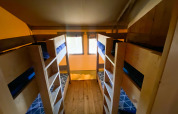 Interior view of the Safari tent at Camp Diekirch in Luxembourg, showing four bunk beds and wooden floor.