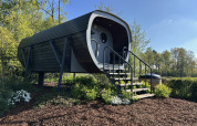 The Anthropod tiny house at Holiday park 't Rheezerwold in the Netherlands, surrounded by greenery.