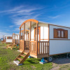 Glamping accommodation at Camping Nordseestrand with pipowagens on grassy fields in Lower Saxony, Germany.