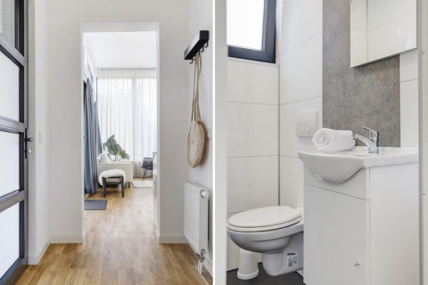Luminoso pasillo con suelo de madera, baño moderno y acogedora sala en Boslodge Plus met Hottub.