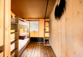 Interior of the safari tent De Bosvilla at Gooise Heide, Netherlands with bunk bed and wooden floor.