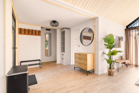 Bright modern interior of Cosy Lodge at Campsite Si-Es-An in the Netherlands, featuring wood accents.