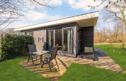 Outdoor photo of a luxury tiny house loft at Campsite Si-Es-An in the Netherlands, modern and cozy.