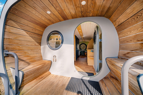 Modern wood interior of the Skycabin at Campsite Si-Es-An in the Netherlands, viewed from oval entrance.