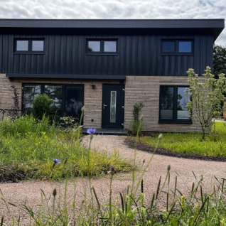 Modern tiny house accommodation at Tinyhouse Ahlenmoor in Lower Saxony, set in natural green surroundings.