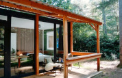 Gemütliche Holzhütte mit überdachter Terrasse im Wald bei Forest Cabin, Outdoors Holten, Niederlande.