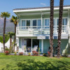 Modern chalet with balcony and palm trees at Campofelice Village Camping at Lake Maggiore, Switzerland.