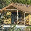 Glamping accommodation at Alfsee Ferien und Erlebnispark – rustic lodge surrounded by greenery in Lower Saxony.