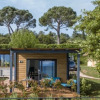 Exterior view of Sentido Lago di Garda Premium Village – Lodges Lombardije surrounded by lush greenery.