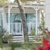 Modern glamping lodge with private porch and hanging chair at Sentido Punta Marina Premium Camp, Emilia-Romagna.