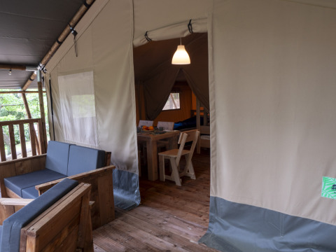Interior of a Safari Lodge tent with wooden furniture on Campsite Des Randonneurs in France.