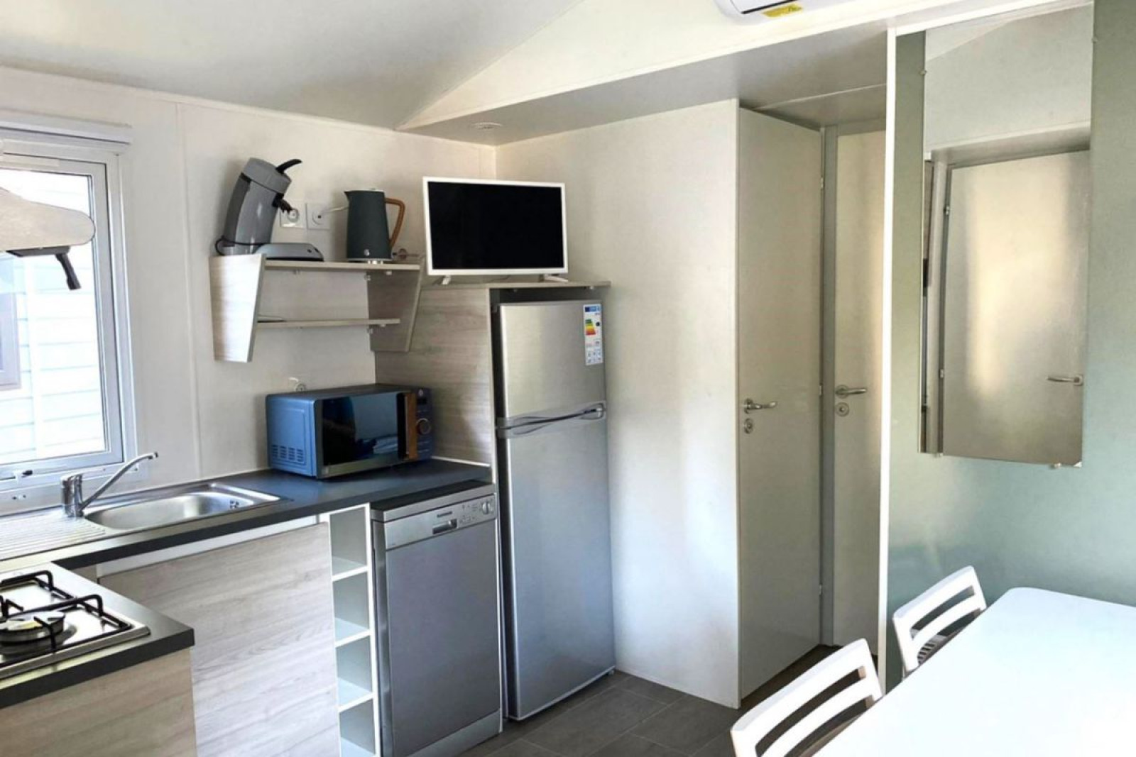 Compacte, moderne keuken in een Comfort Mobile Home bij Camping Paradis Family des Issoux in Frankrijk.