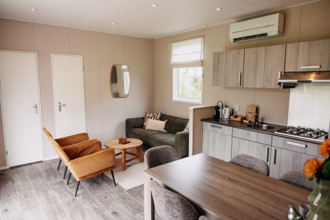 Modern living and kitchen area inside a luxury chalet at Recreation park De Achterste Hoef, Netherlands.