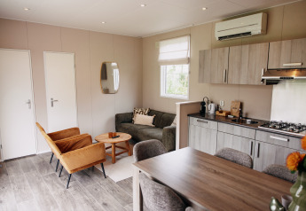 Modern living and kitchen area inside a luxury chalet at Recreation park De Achterste Hoef, Netherlands.