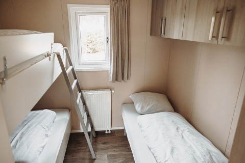 Bright room with bunk beds and single bed in a luxury chalet at De Achterste Hoef, Netherlands.