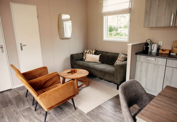 Modern living room in a luxury chalet at Recreation park De Achterste Hoef in the Netherlands, cozy and stylish.