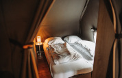 Interior of a cozy double bed setup at Water lodge, Recreation park De Achterste Hoef, Netherlands