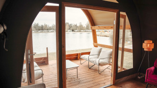 View from inside the Water Lodge at Recreation park De Achterste Hoef in the Netherlands with lakefront deck.
