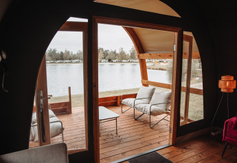 View from inside the Water Lodge at Recreation park De Achterste Hoef in the Netherlands with lakefront deck.
