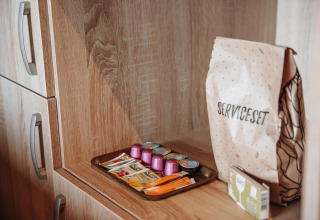 Service kit with coffee capsules, tea sachets and creamer at Water Lodge in Recreation Park De Achterste Hoef.