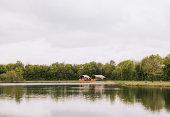 Scenic view of Water lodge at Recreation park De Achterste Hoef in the Netherlands by a tranquil lake.