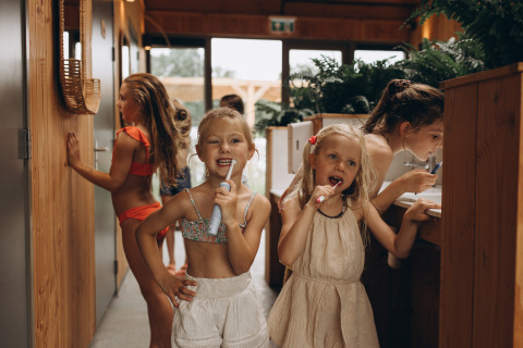 Des enfants se brossent les dents et profitent de leur séjour au camping De Kleine Wereld à Groningue.