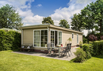 Udendørs billede af Chalet 4 ved Tolplas i Holland med have, terrasse, havemøbler og grønne omgivelser.