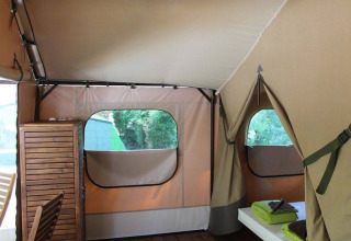 Interno della tenda safari Kenya Lodge con mobili in legno al Camping les Rives de Grand Lieu, Francia.