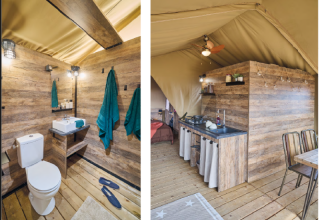 Innenraum eines Safari-Zeltes der Kenya Lodge bei Flower Camping Le Pont du Tarn, Frankreich, mit Bad und Küche.