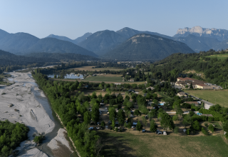 Aerial view of the landscape near Vercheny, Auvergne-Rhône-Alpes, France, with a river and mountain backdrop.