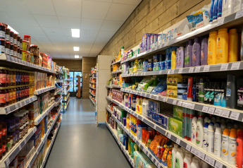 Et billede af en butiksgang på en lodge med hylder fyldt med madvarer og personlige plejeprodukter.