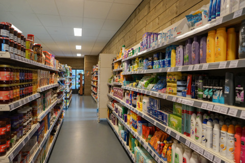 A photo of an aisle at a lodge store, with shelves stocked with groceries and personal care products.