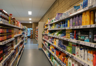 A photo of an aisle at a lodge store, with shelves stocked with groceries and personal care products.