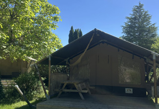 Safari tent Compact at Campsite Les Bois du Bardelet in France beneath a clear blue summer sky.